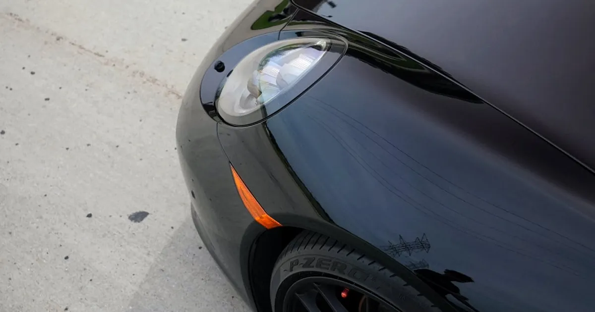 Side-by-side comparison of PPF and ceramic coating on a luxury vehicle